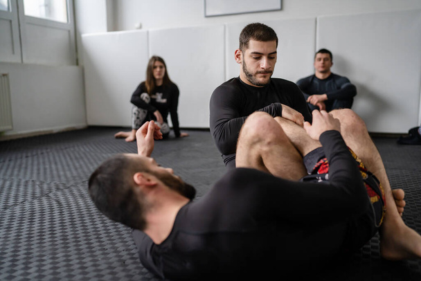 Two men demonstrate bjj brazilian jiu jitsu grappling